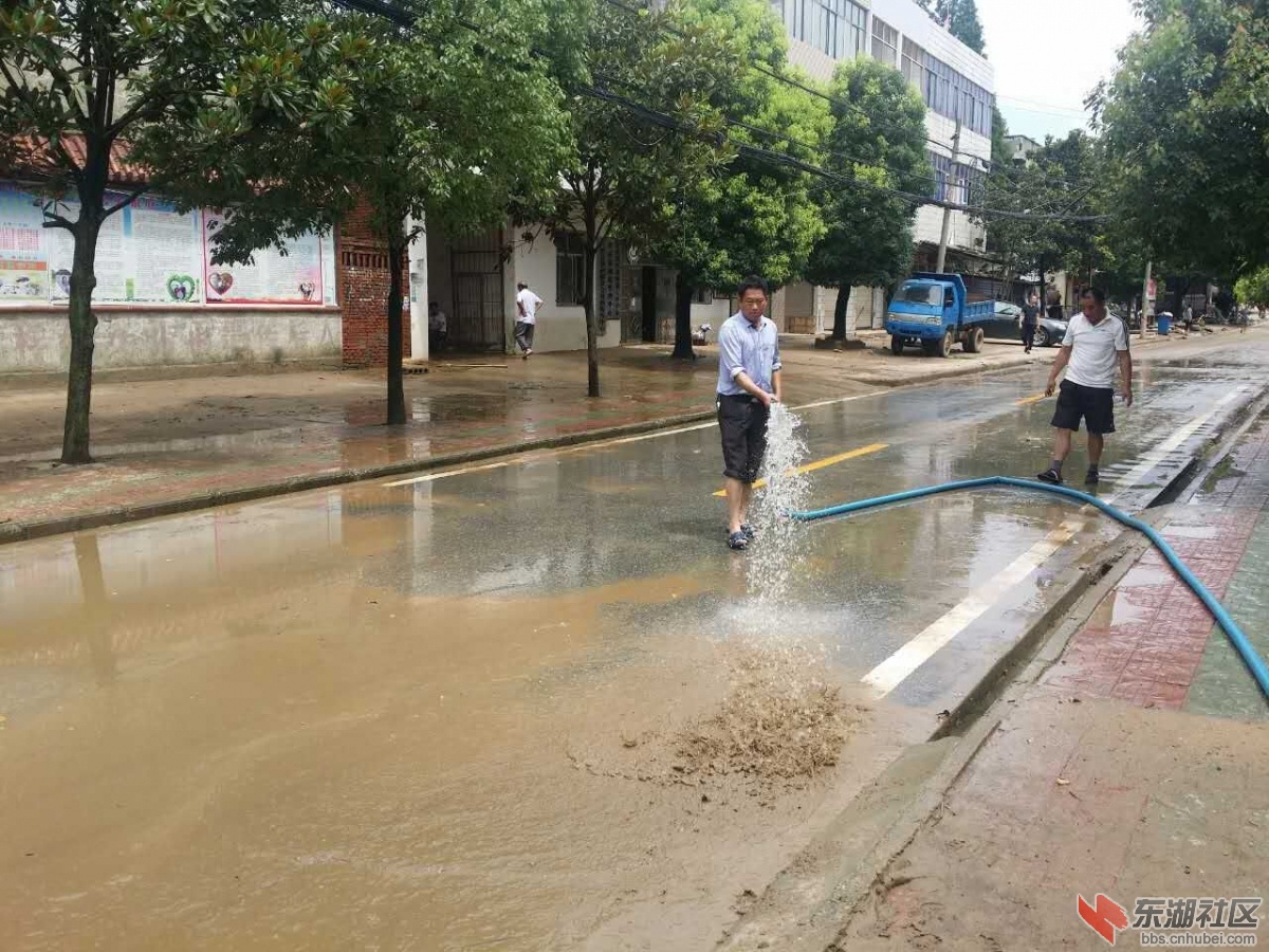 政府干部冲洗街道淤泥.jpg