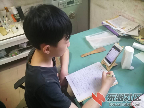 图为学生在家里认真听的线上班会